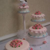 005.jpg I made this wedding cake for a friend of my husbands' and she loved it. The roses are all handmade fondant and gumpaste roses. Took me...