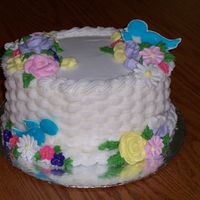 Wilton Course Ii Final Cake Small oval cake, basketweave with BC, flowers in Royal and Birds in color flow.