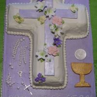 First Communion Cake This is a 12x18 sheet cake with the cross pan that I made for my niece. The rosary, purple cross, chalice and wafer are fondant.