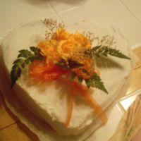 My First Wedding Cake This is the topper for my daughters wedding cake. Heart shape with orange roses,