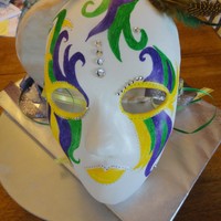 Mardi Gras Mask This was a red velvet cake with Raspberry cream cheese frosting cover in Ronda's MMF. The mask is gum paste and I drew on teh design...