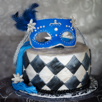 Mask In Blue This was a chcolate and chi cake torted with lemon honey bc covered in mmf. I made the mask out of gum paste as well as the flowers. TFL. I...