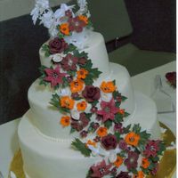 Fall Wedding This is a buttercream wedding cake with royal and fondant flowersand leaves The only thing not edible on the cake is some small plastic...