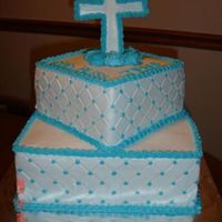 Boy 1St Communion Bottom layer white cake, top layer choclate cake, both chocolate buttercream filling. Diamond Impression with light blue dots and border....