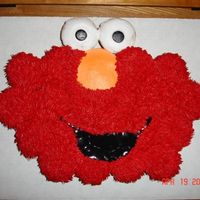 Elmo Cupcake Cake White cupcake cake with buttercream and rolled buttercream mouth and black of eyes. Thanks for looking!