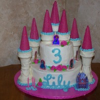 Disney Princess Castle Cake My niece had a Disney Princess party for her 3rd bday. 10" and 6" rounds and candy coated ice cream cones for the towers. Colors...