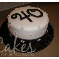 40 Daisies Chocolate Cake made for a co-workers 40th. Covered with fondant and fondant accessories.