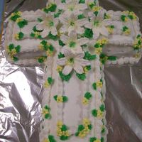 Easter Lily Cross Cake Cake is vanilla with vanilla buttercream. Flowers and easter Lilies are royal icing. Made for a church Good Friday Dinner.