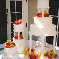 Tulips And Pearls This was my first paid wedding cake. I was sooo nervous. decorated in all bc with real pearl strands around it. Fresh tulips as toppers....