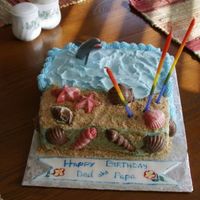 Dad's Birthday Cake The cake is chocolate w/buttercream (w/almond twist) icing. The banner is fondant decorated with edible markers. The shells are marbled...