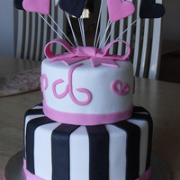 Pink And Black Hearts chocolate cake with fondant hearts, stars and bow.