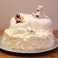A Polarbear Cake For My Sons 2:d Birthday. Layerd cake with moussefillings, covered with whipped cream and sugarpaste fr&aring;n Balina. Animals made of modellingpaste.