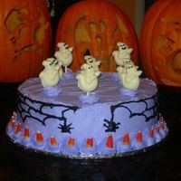 Ghostly Cake This was a cake for my daughter's class Halloween party. I made the ghosts from white chocolate candy molds.