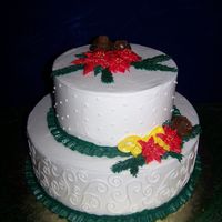 Bc Christmas Buttercream cake, BC swirls and dots, BC poinsettias, leaves and ribbon. It was very hot and my BC was not cooperating, so flowers are a...
