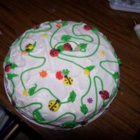 100_0546.jpg this is a butter cake with vanilla icing and royal icing flowers and bugs