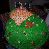 100_0539.jpg grass is buttercream and the flowers are royal icing,and the ants and picnic or fondant, this is my first time making figures.