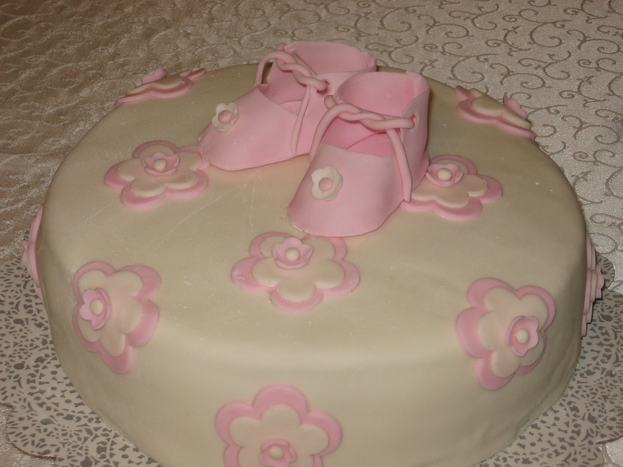 Booties And Flowers My first attempt at gumpaste booties! Thank you to JaneK for the template. Inspiration for this cake is from the middle tier of a cake by...