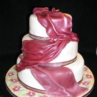 Maroon And Ivory Draped Cake 3 tier maroon and Ivory fondant cake with fondant covered mosaic board.
