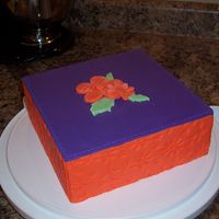 Square With Fondant made this one in one of the wilton's cake decorating classes. used fondant for all of it. used one the mats to create that embossed...