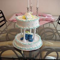 Baby Shower Cake All buttercream and real booties and pacifiers on top.
