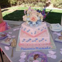 Tiered Pink Cake With Fondant Bow And Fresh Flowers tiered pink cake with fondant bow and fresh flowers in between the bow.
