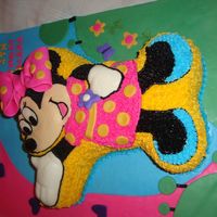 Minnie Mouse Cake I used Mickeys pan double layered it and modified it to look like minnie. It's all buttercream with the exception of the face, hands...
