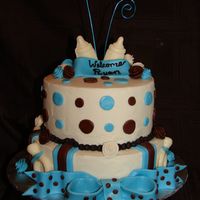 Blue, Brown And Polka Dot Boy Baby Shower Cake The cake is covered in buttercream and the decorations are made of Marshmallow fondant and some candy melts for the bottle and pacifier.