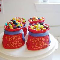 Bertie Botts Beans Mini-wondermold cakes covered in fondant & topped with jelly beans. I got the idea from an old Wilton Yearbook.