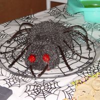 Black Spider Cake My first attempt at themed cake decorating. The head and body are devil's food cake baked in FireKing bowls. The icing is fudge tinted...
