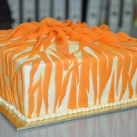 Stripes Cake Moist Vanilla cake with Butter icing, fondant accents. Thank you for looking.