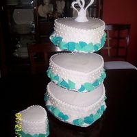 3Tier Heart Shape My first actual wedding cake! Done in all bc icing with gum paste leaves around bottom borders. The extra tier to the side was added in to...