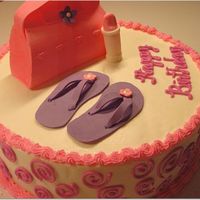 Girly Birthday Cake Buttercream with Gumpaste pocketbook, flip flops and tube of lipstick.