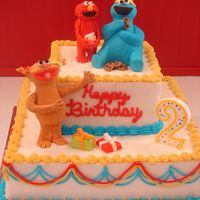 Sesame Street - Elmo, Cookie Monster And Zoey Figures were made from gumpaste (started with rice crispy treats the covered). This was my first attempt at figures....wasn't real...