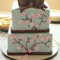 Cherry Blossom Engagment Cake Cherry Blossom Engagement Cake. Meringue Buttercream iced. Gum paste and fondant accents. Hazelnut and triple chocolate cake layers....