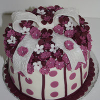 Birthday Cake For My Mil I made this cake this past August for my MIL's birthday. It was carrot cake iced in buttercream. The bow and flowers are fondant.