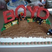 Monster Trucks chocolate letters, purchased monster trucks, chocolate whipped BC on top , regular whipped BC for sides and grass. more monster trucks were...