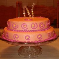 Swirls White cake with Buttercream Icing. I used the Viva Paper towel method. Orange with fucia swirls.