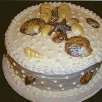 Seashell Anniversary buttercream, shells are chocolate painted with pearl dust. Last minute surprise 50th anniversary party dinner.