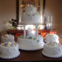 Jerri And Jason's Wedding 3 tier with 4 satilite cakes with yellow and lavender roses made from my homemade buttercreme icing.