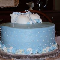 Baby Booty Cake Made for a baptism. WASC with crusting cream cheese icing. Fondant buttons and booties.