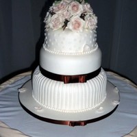 Wedding Cake Three tier cake made of fruit,covered with almond paste then fondant.Gumpaste roses.