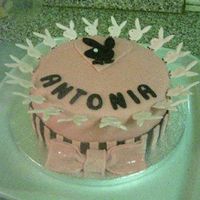 Playboy chocolate with chocolate fudge filling, covered with sugarpaste, the little heads around the edge are royal icing then "stuck" to...