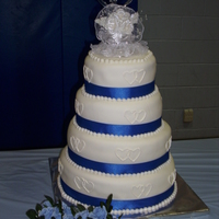 Blue And White Wedding This cake was huge. The cakes are covered in mmf with buttercream hearts and mmf pearls.