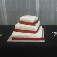 Red And White Wedding Cake is covered in mmf with buttercream accents on the side