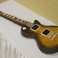 Gibson Les Paul This was a cake of the Groom's guitar. It was covered with fondant and airbrushed.