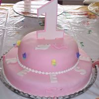 1St Birthday Cake I made this cake for my husband's goddaughter. Strawberry cake with strawberry filling. Covered in mmf. I also made a matching smash...