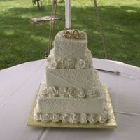 50Th Anniversay, Squares 6, 9 and 12inch squares. Iced in buttercream with roses and cornelli lace.. "50" made from gumpaste and painted with gold...