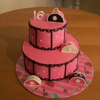 Sweet 16 6 and 10 stacked rounds. Iced in pink buttercream with fondant accents. Purses are cake covered in fondant with royal handles. "16&...