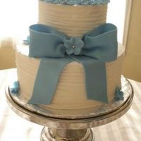 Blue Bow 2 tier round wedding cake (dummy) Blue Bow and flowers done in fondant.