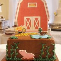 Farm With Barn 8" square iced in chocolate buttercream with fondant farm animals. A different one on each side. Piped "corn stalks"....